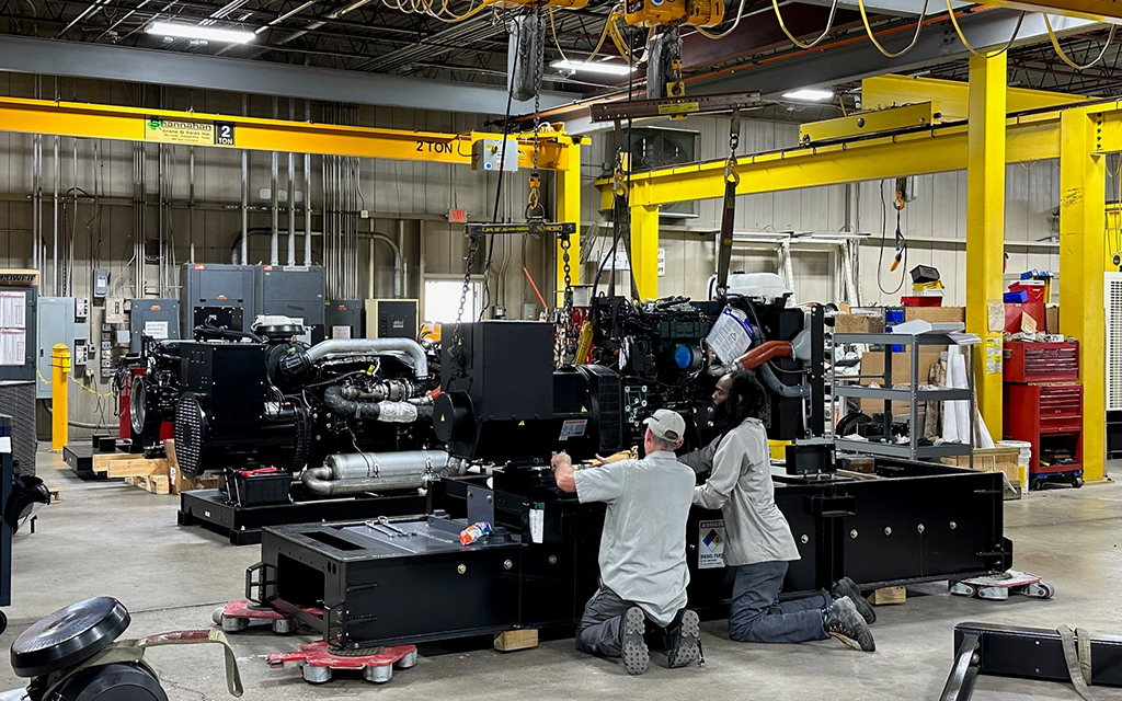 The image shows an industrial shop floor of CK Power, an off-highway power solutions provider. 